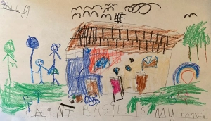A picture drawn by a child of a house and figures standing next to it. Written on the picture is, 