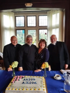 Deacon Kyriakos Ioannou's ordination celebration with him and other in front of a cake