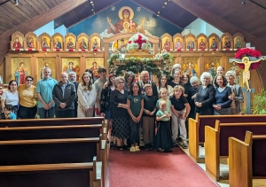 Congregants posing in front of an iconostasis during Holy Week