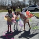 Three girls posing with their kites outdoors