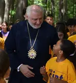 Archbishop Elpidophoros looking at a boy at Camp Saint Paul