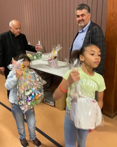 Two girls getting their Easter basket at the panygiri-style Easter Picnic put on by the PanGregorian Enterprises of New Jersey