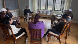 Adults sitting in a circle with Dr. Mamalakis leading a parenting workshop