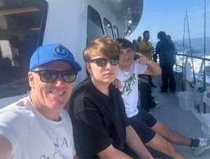 Saint Basil Academy youth on the deck of a chartered fishing boat with AHEPA Chapter 319 members