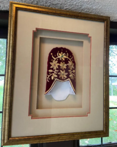 The relic of Saint Basil's slipper in a frame hanging at Saint Basil's Chapel at Saint Basil Academy