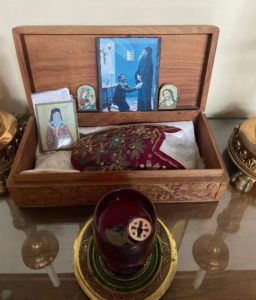The relic of Saint Dionysius of Zakynthos' slipper in a wooden box surrounded by icons of the saint at Saint Basil Academy