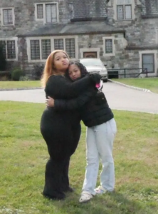 Two girls hugging each other outside of Saint Basil Academy