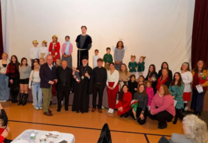 Saint Basil children and youth with Archbishop Elpidophoros, Father Costa, and other adults after the Christmas pageant