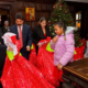 Archbishop Elpidophoros and other adults holding large bags of gifts for the children and youth of Saint Basil Academy