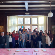 A group of youth with Father Costa and Deacon Kyriakos with Vasilopita on the table in front of them