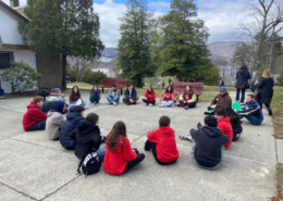 Youth sitting in a circle outside the Saint Basil Chapel at the 2026 GOYA Retreat