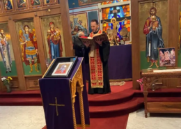 Father Nikolas Delaveris reading the gospel during a paraklesis service at Saint Basil Chapel