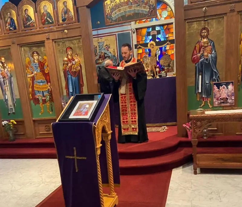 Father Nikolas Delaveris reading the gospel during a paraklesis service at Saint Basil Chapel
