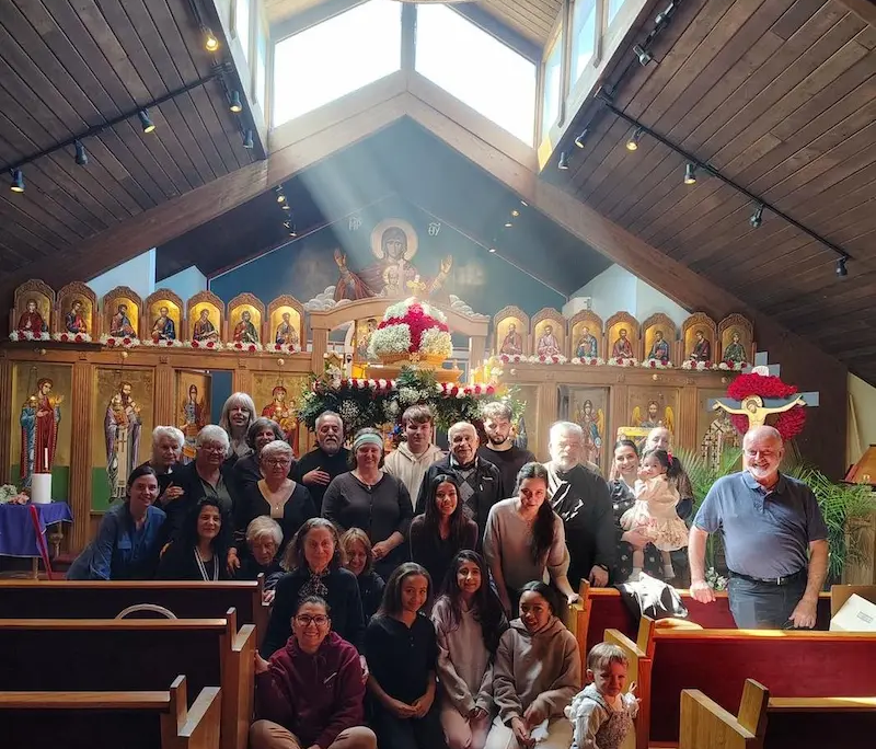 A group posing in front of the iconostasis at Saint Basil chapel for Good Friday