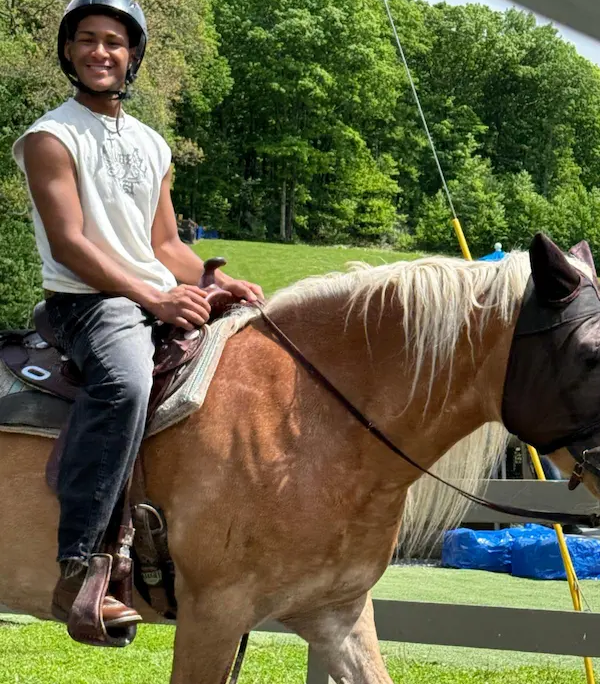 707012630_1274808291479396_6102730462860882153_n A youth from Saint Basil Academy riding a horse while visiting the Rocking Horse Ranch