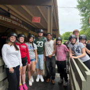 Saint Basil Academy youth at on a trip to Rocking Horse Ranch standing outside the stables.