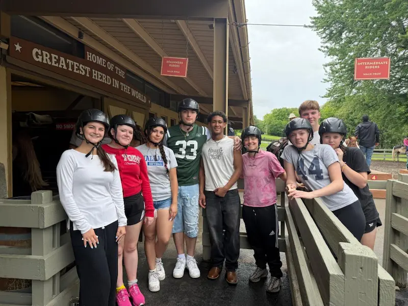 Youth at Rocking Horse Ranch Saint Basil Academy youth at on a trip to Rocking Horse Ranch standing outside the stables.