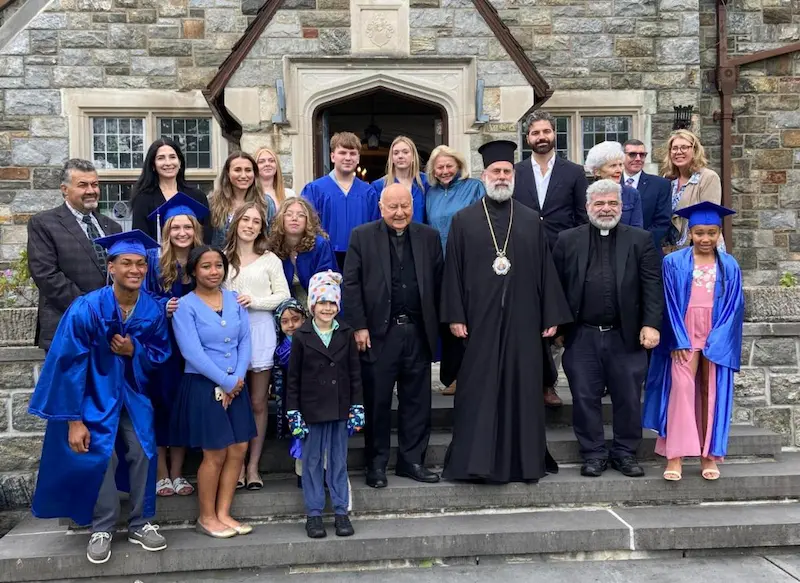 2026 graduation A group of Saint Basil Academy graduates and staff in front of the main building.
