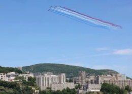 The French Aerobatic Team flyover Jets of the French Aerobatic Team flying over West Point Military Academy with trails of red, white, and blue.