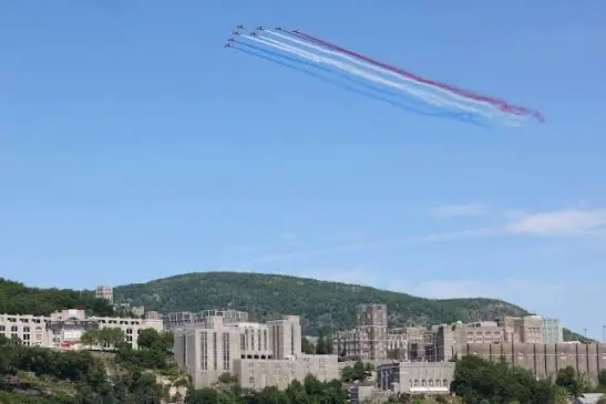 The French Aerobatic Team flyover Jets of the French Aerobatic Team flying over West Point Military Academy with trails of red, white, and blue.