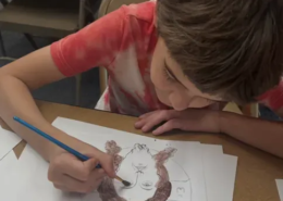 A boy painting an icon of Christ A boy painting an icon of Christ