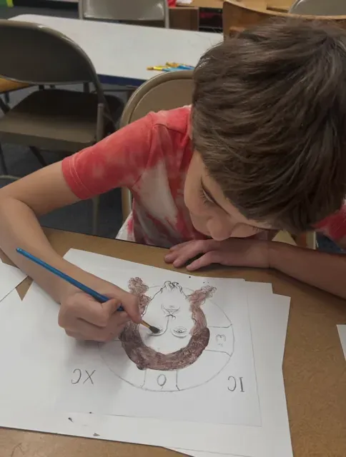 A boy painting an icon of Christ A boy painting an icon of Christ