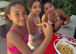 Girls on an outing Three girls eating french fries at a picnic table