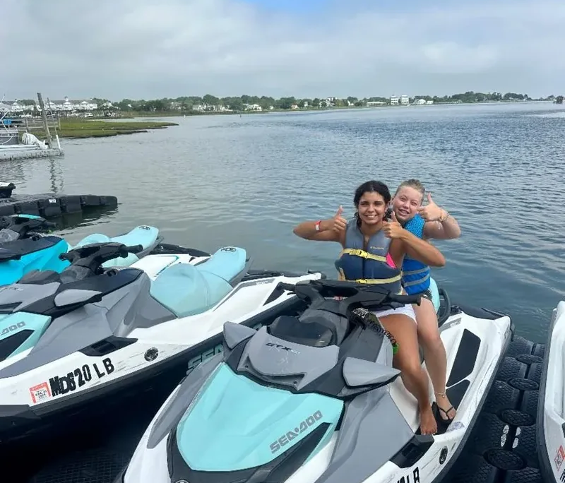 Ocean City youth field trip Two female youth sitting on a jet ski wearing life jackets during a Saint Basil summer field trip to Ocean City.