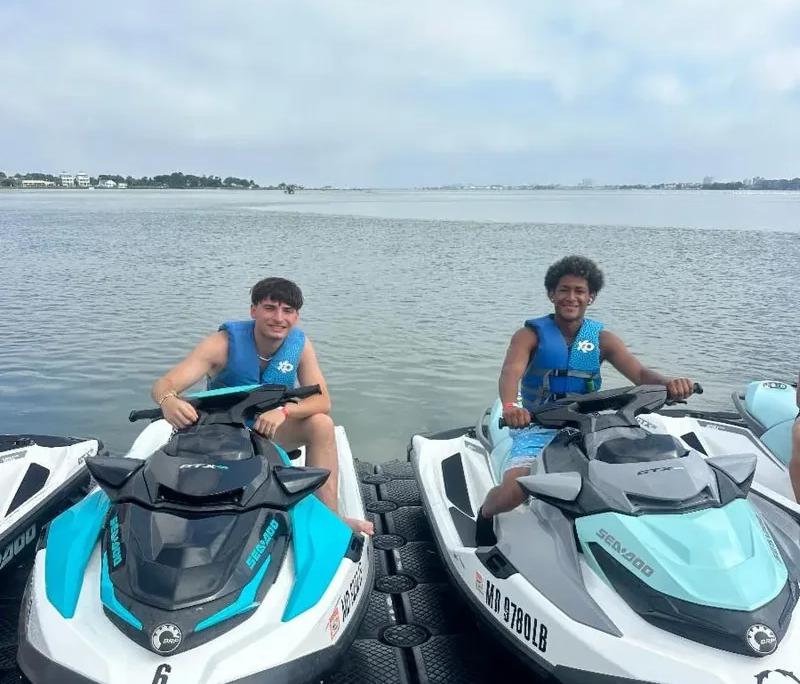 Ocean City youth field trip Two male youth each sitting on a jet ski wearing blue life jackets during a Saint Basil summer field trip to Ocean City.
