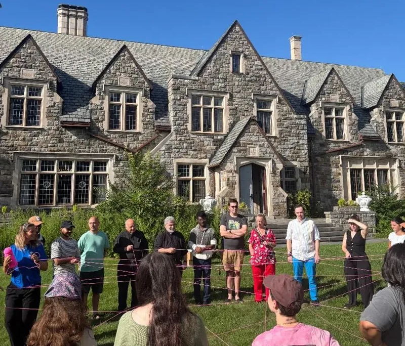 Staff in-service training Saint Basil Academy staff outside in a circle holding string interconnected string during an in-service training