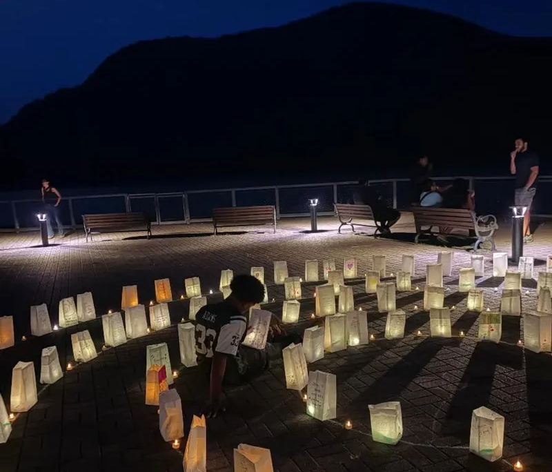 Overdose Awareness Remembrance Night Illuminaries on a patio for an Overdose Awareness Remembrance Night that Saint Basil staff participated in