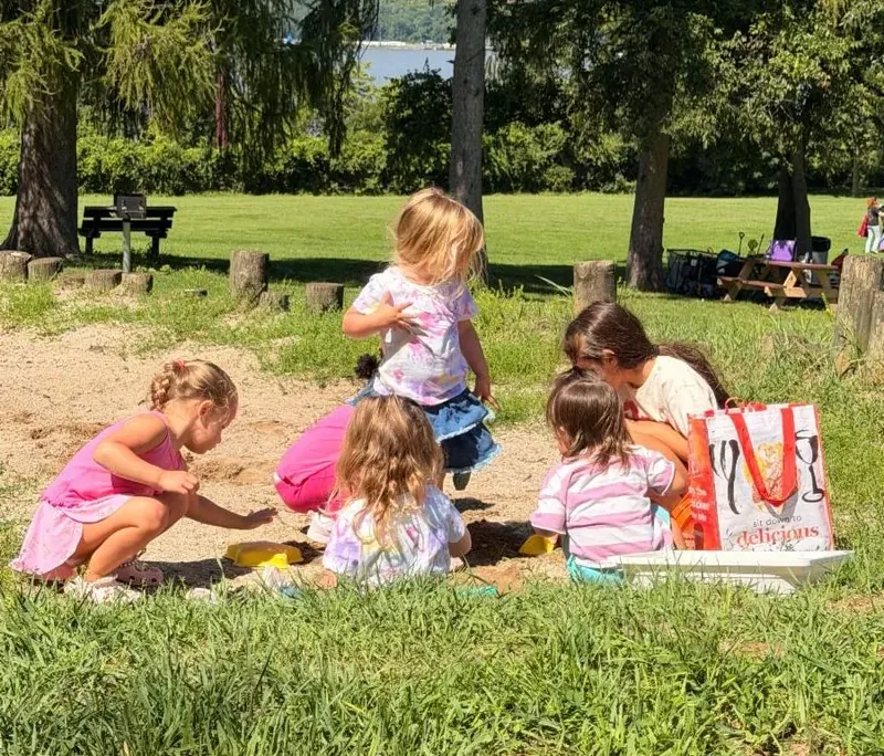 Summer playtime Five young girls playing in the sand on the Saint Basil Academy campus.