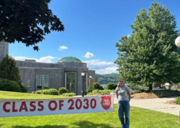 A new school year begins A Saint Basil female youth standing on a lawn with a sign that says, "Class of 2030."