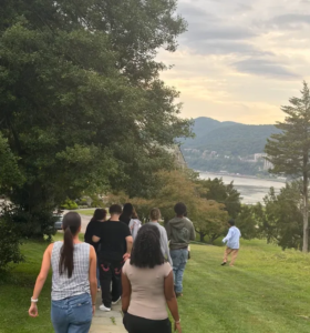 Youth walking outside at Saint Basil Academy with the Hudson River in the background